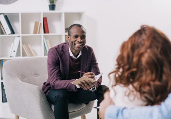 a coach and client meeting and the coach displaying emotional attunement to their client