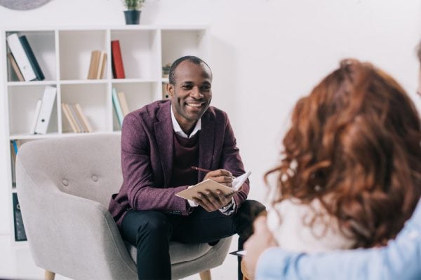 a coach and client meeting and the coach displaying emotional attunement to their client