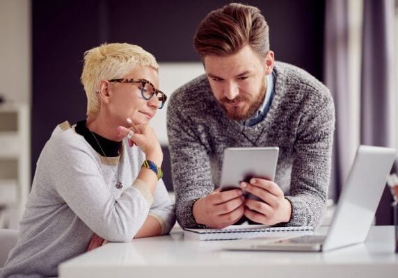 coach and client looking at a small tablet