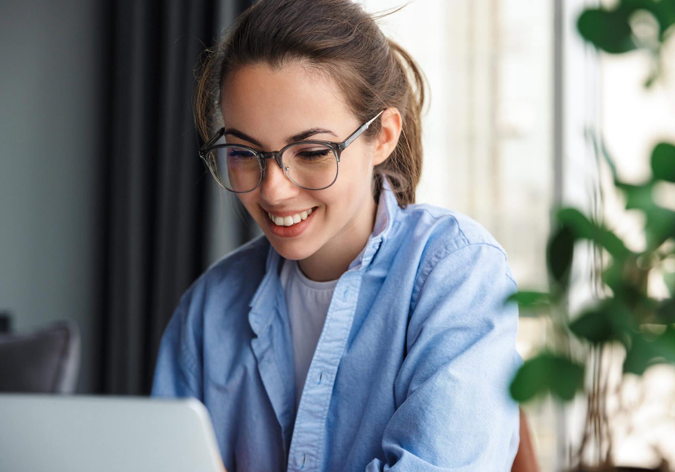 Image,Of,Pleased,Nice,Woman,Using,Notebook,And,Smiling,While