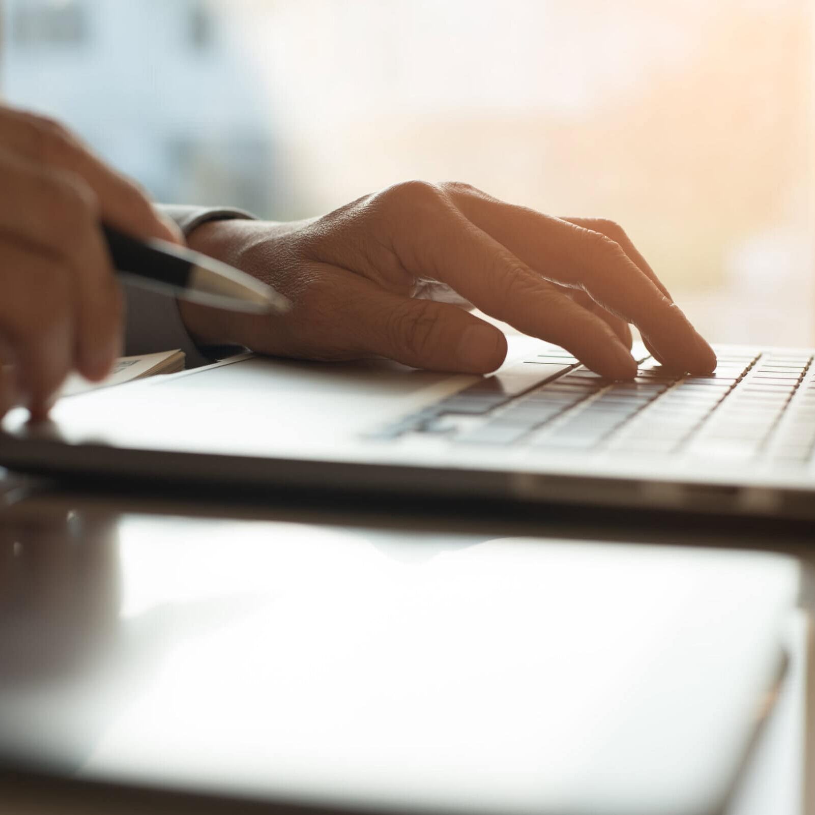 Businessman,Working,On,Laptop,Computer,And,Hand,Holding,Mobile,Smart