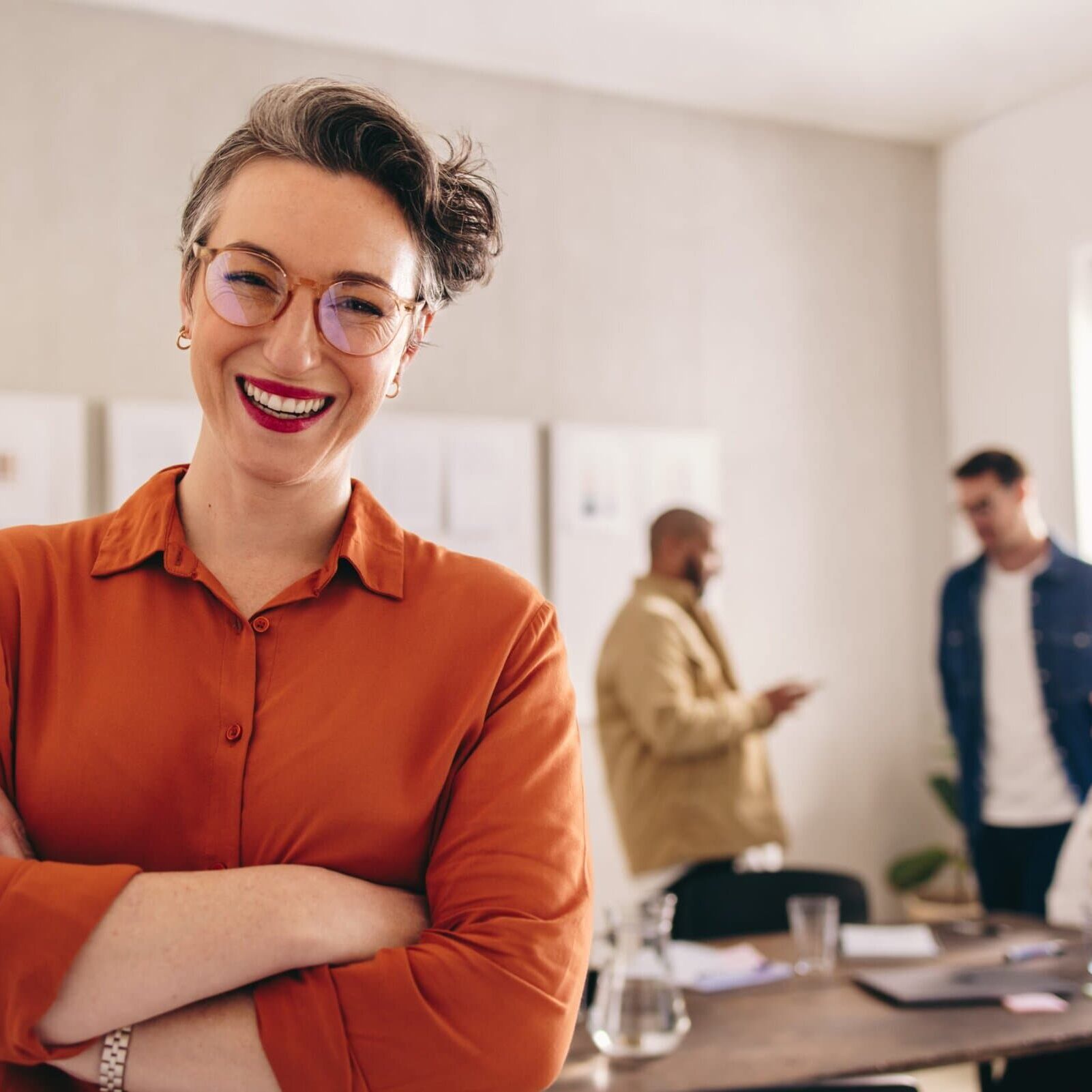 Cheerful,Businesswoman,Smiling,At,The,Camera,While,Standing,In,An