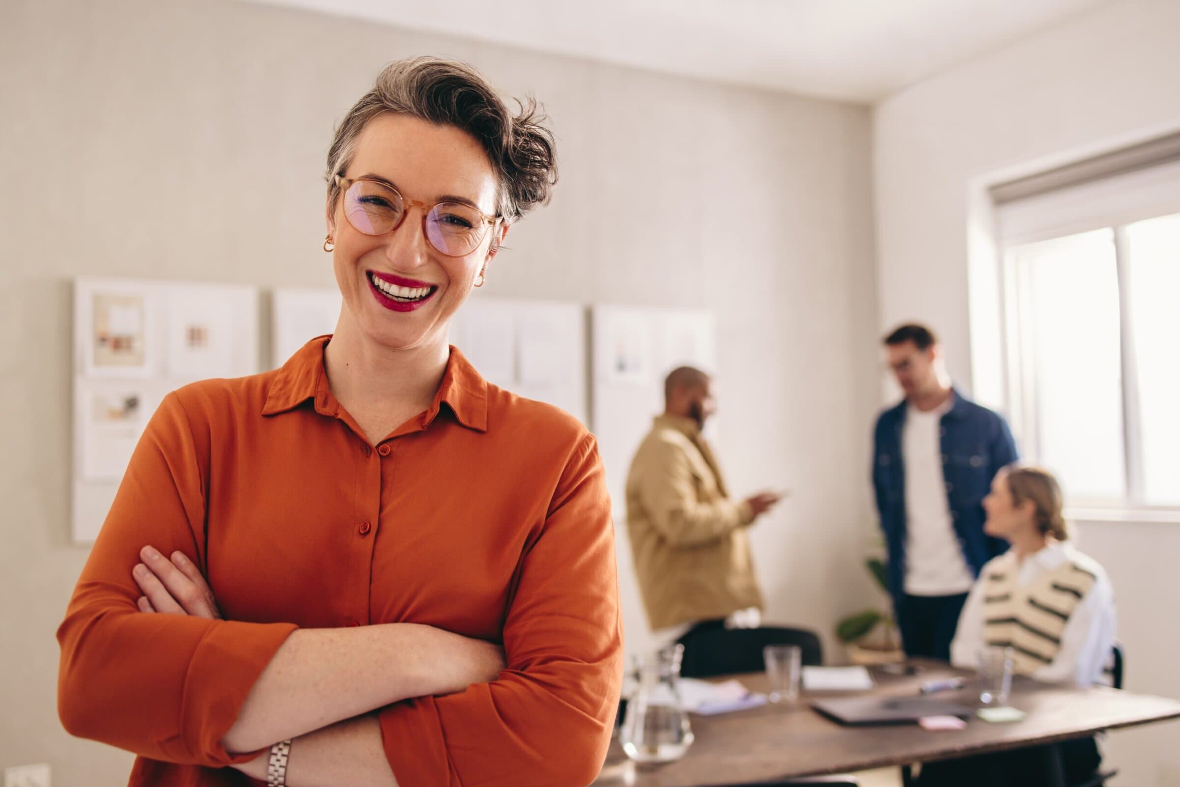 Cheerful,Businesswoman,Smiling,At,The,Camera,While,Standing,In,An