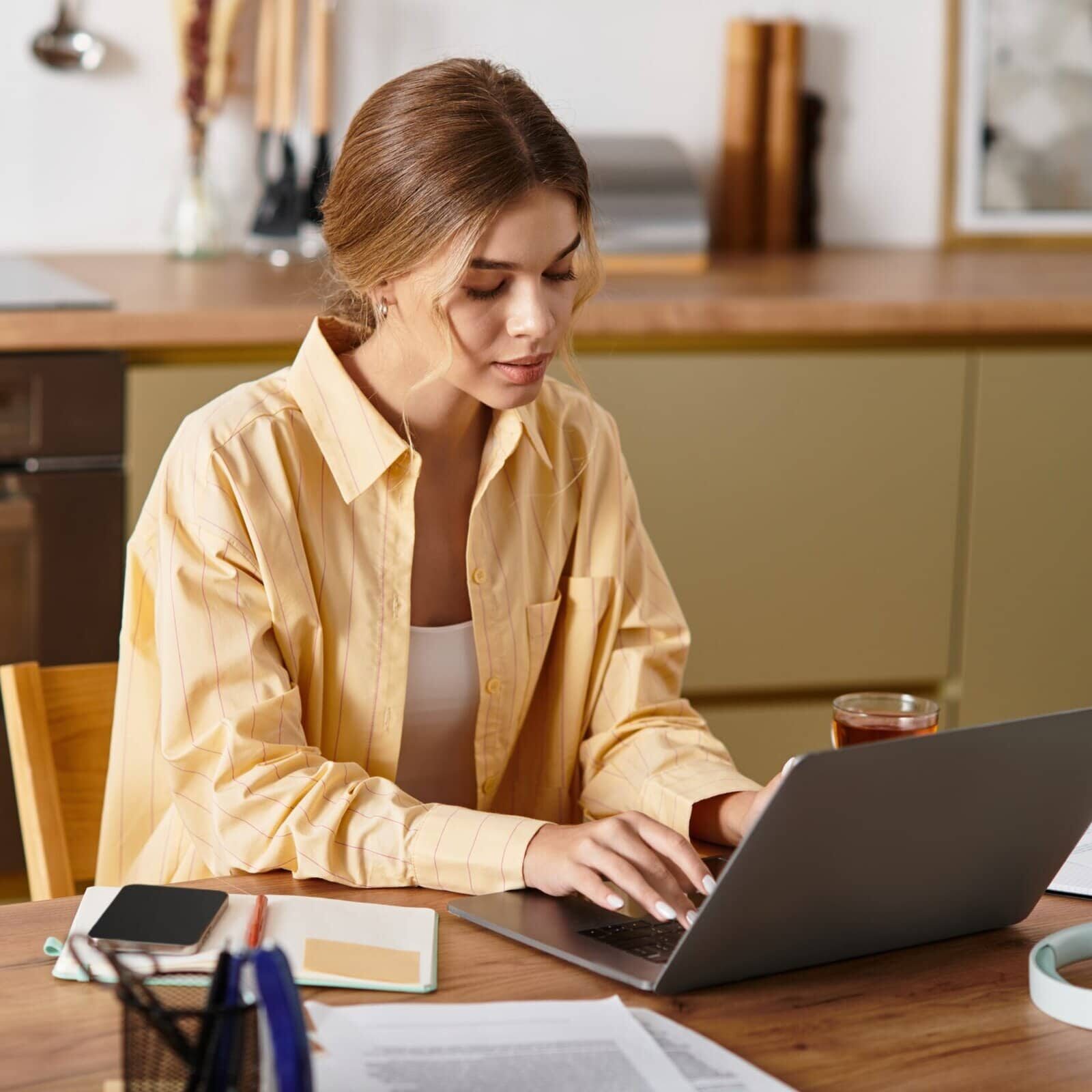 Young,Woman,Focuses,On,Her,Work,At,Home,,Surrounded,By