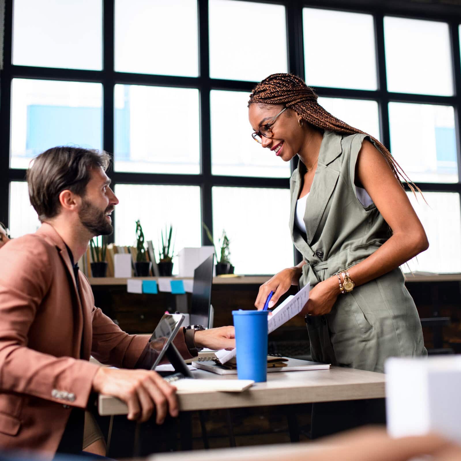 Portrait,Of,Young,Business,People,Working,Indoors,In,Office,,Talking.