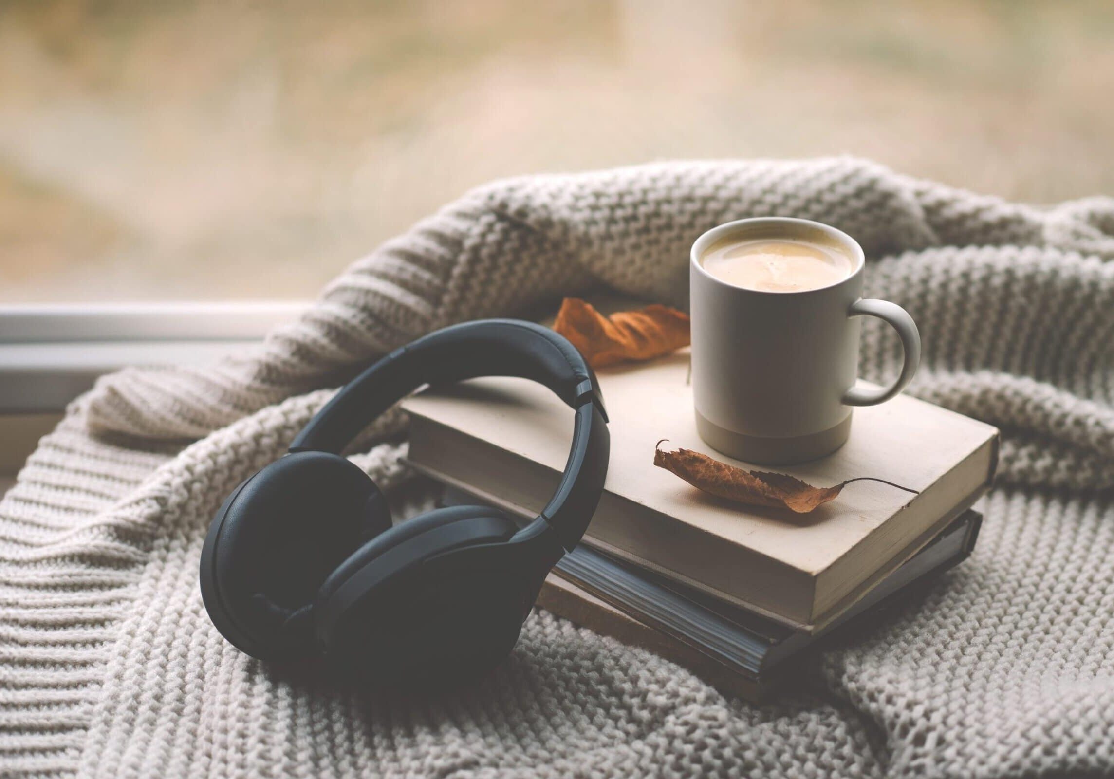 A,Pair,Of,Black,Headphones,Lies,On,An,Book,,Surrounded