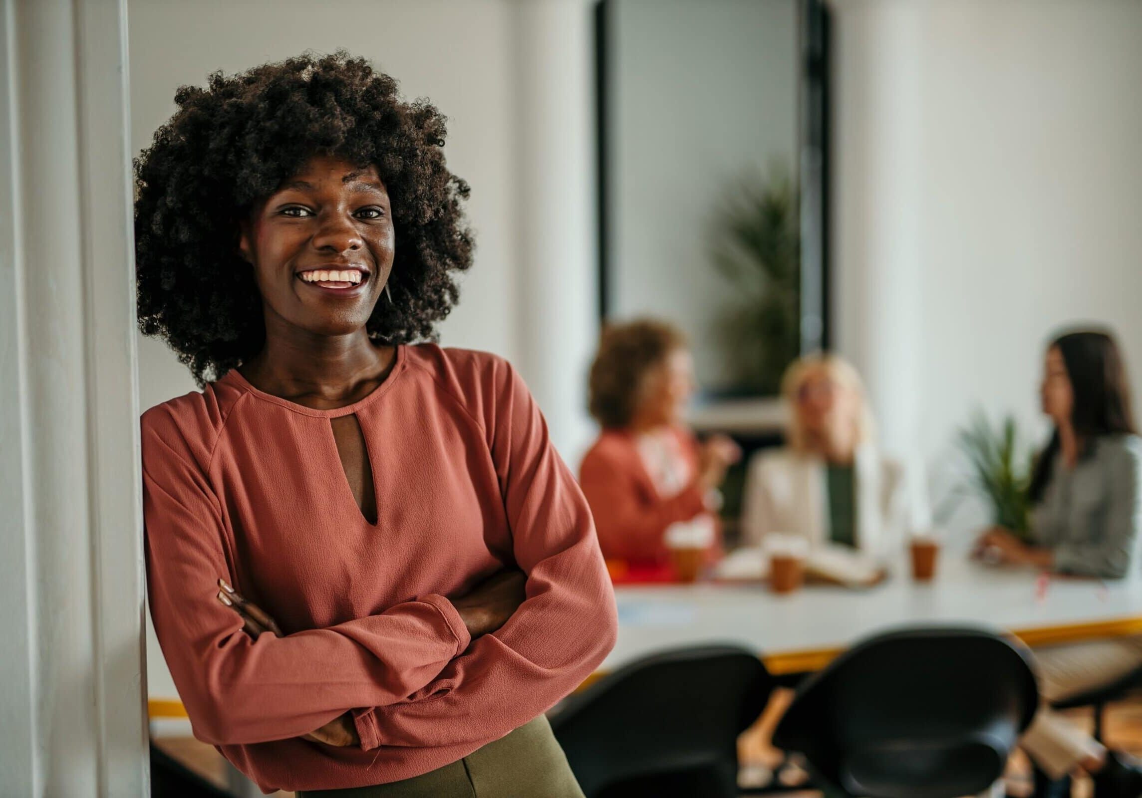Shot,Of,A,Beautiful,Smiling,Businesswoman,Standing,In,Front,Of