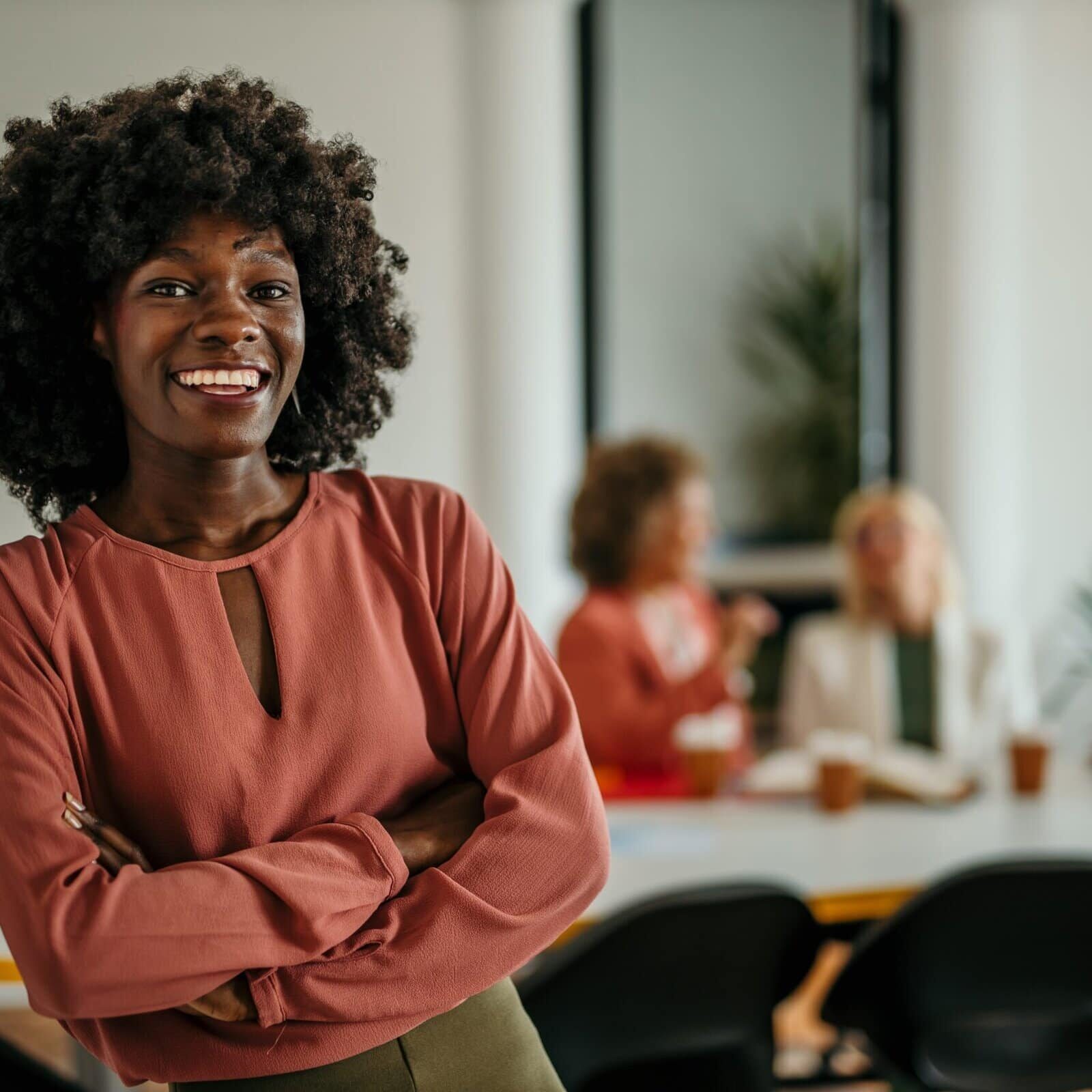Shot,Of,A,Beautiful,Smiling,Businesswoman,Standing,In,Front,Of