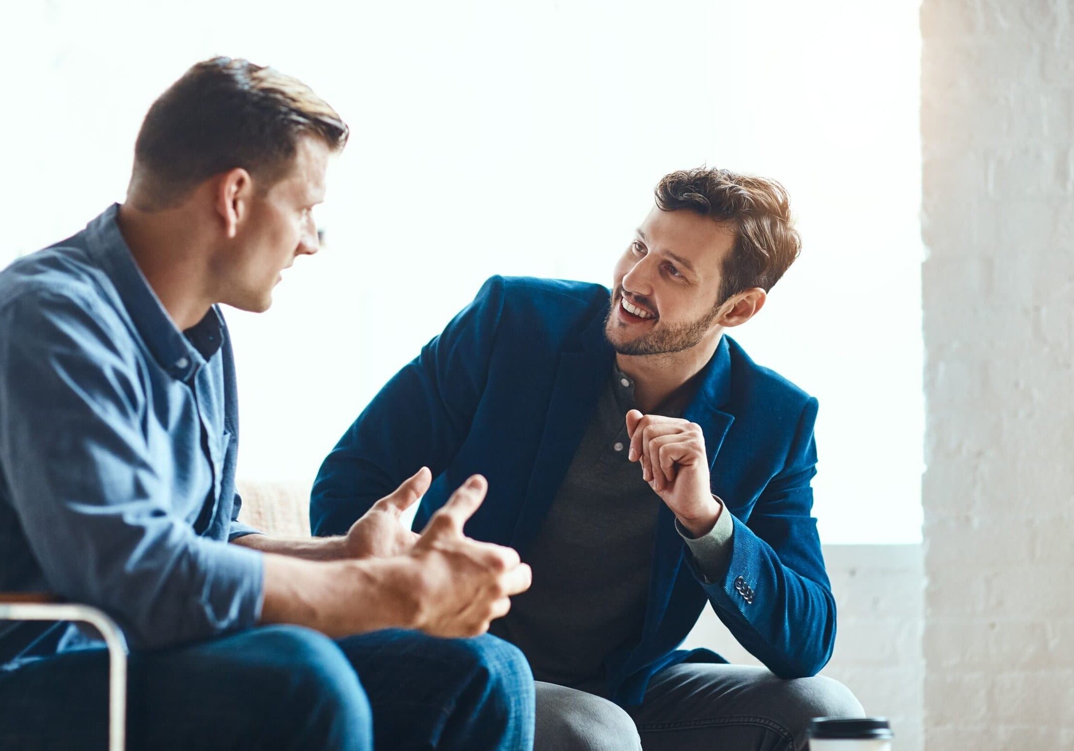 Talking,It,Over.,Two,Young,Businessmen,Chatting,While,Working,Together