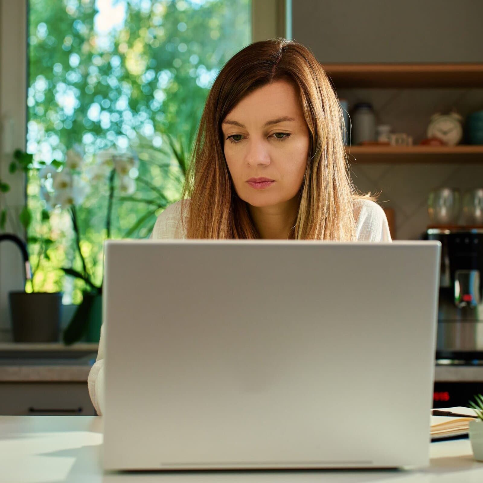 Focused,Woman,Typing,On,Laptop,At,Home,Office,Desk.,Millennial