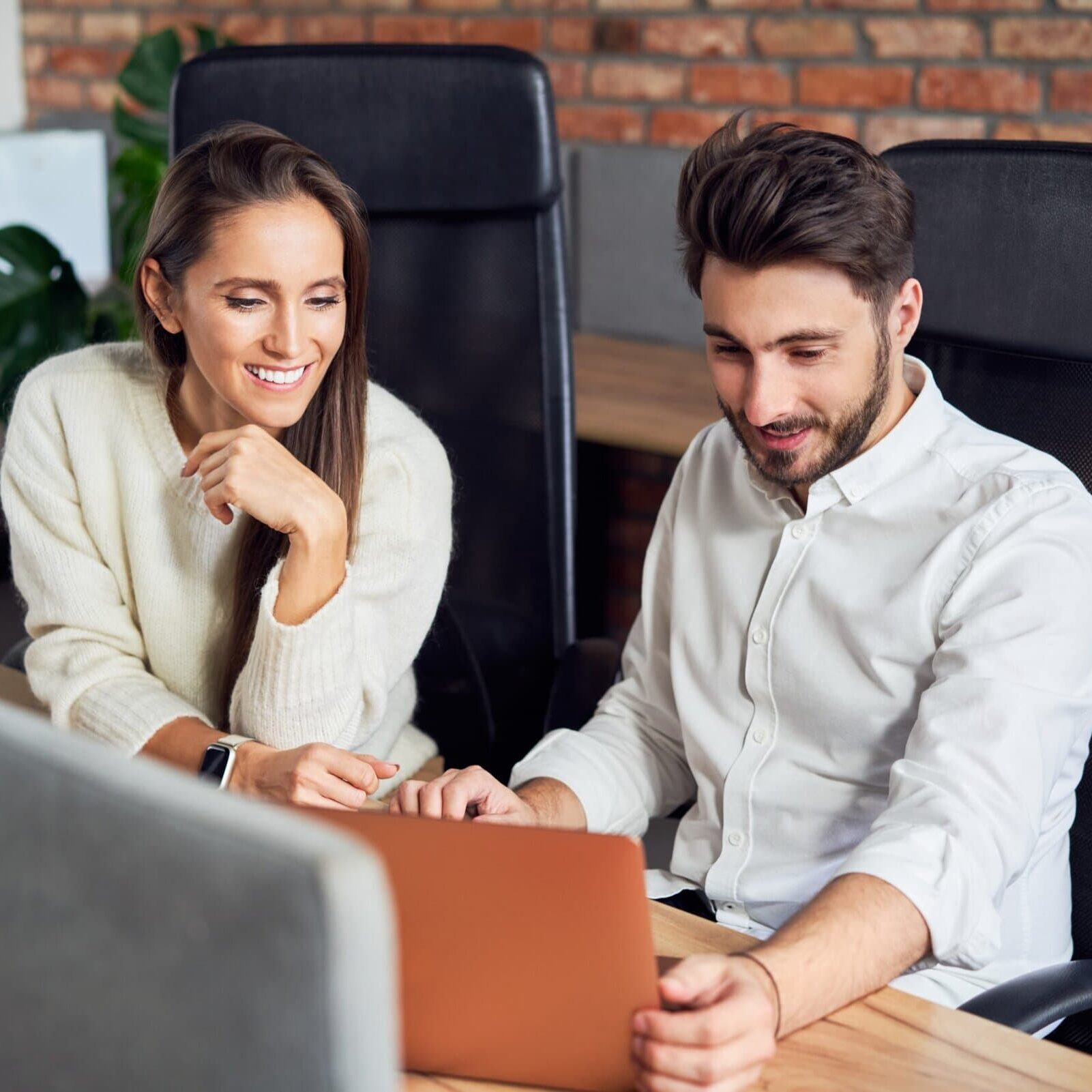 Two,Young,Business,People,Talking,In,Office,Using,Laptop,During