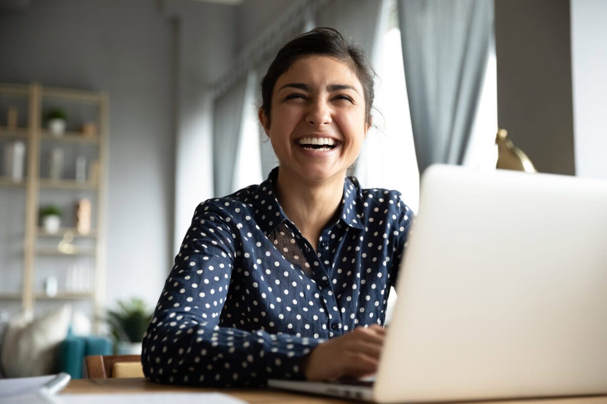 smiling coach at a laptop