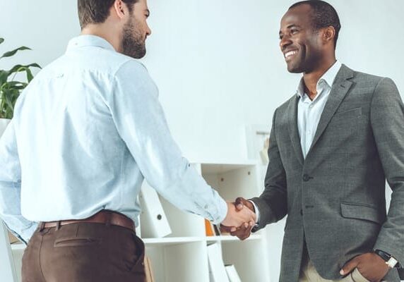 person meeting their coach for the first time and shaking hands