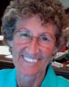 Teri E Belf MCC headshot photo, woman wearing glasses and a turquoise top